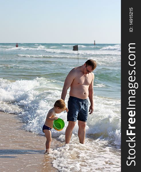 Father and son playing at sea