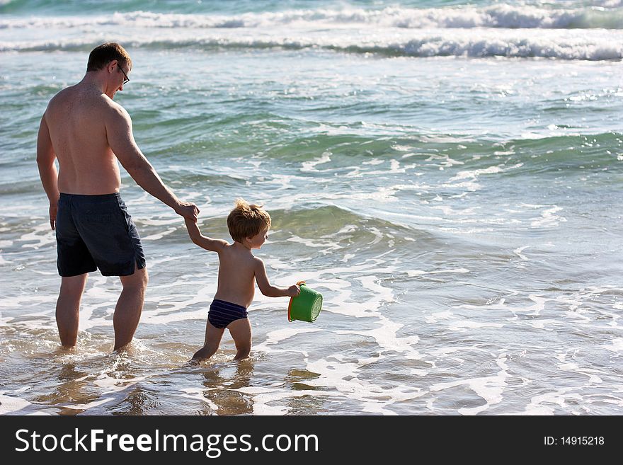 Father and son playing at sea