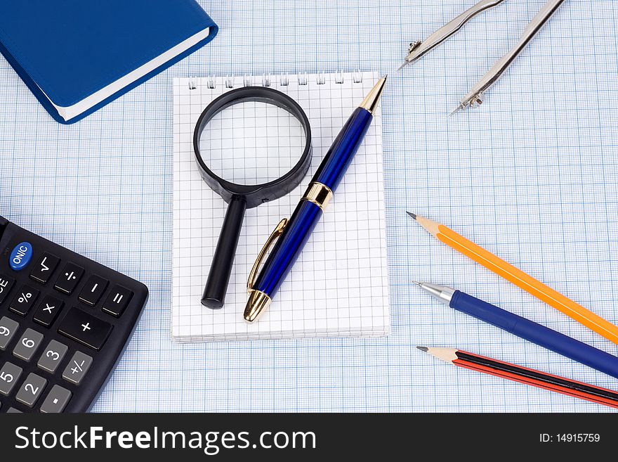 Book, calculator and pens at paper. Book, calculator and pens at paper