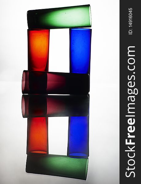 Colorful glasses on reflected table
