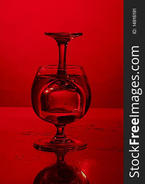 Glass in glass on red background