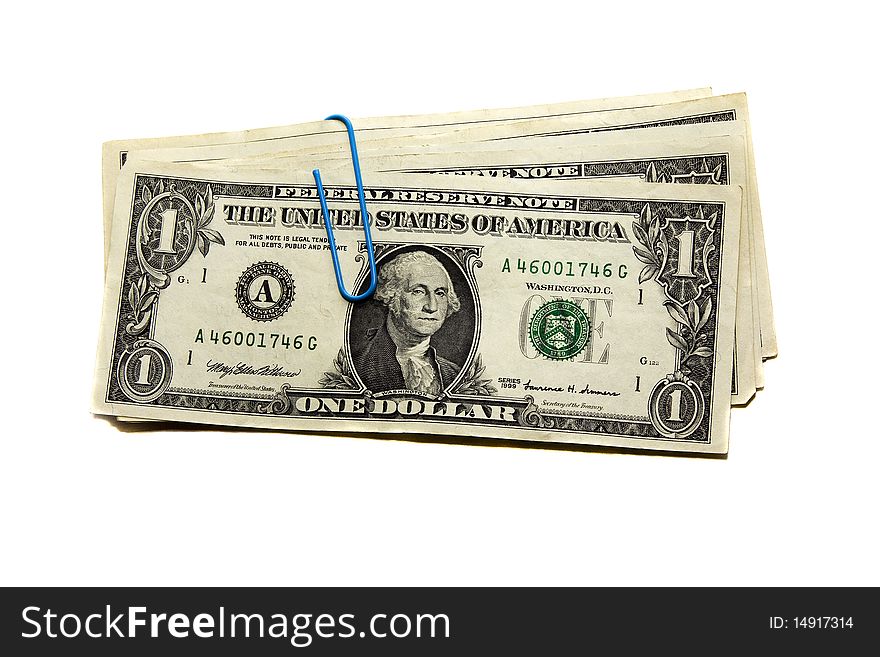 The American dollars combined together and fastened by a writing paper clip. The American dollars combined together and fastened by a writing paper clip