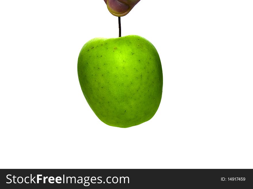 Green apple, which hold for tail by fingers. Green apple, which hold for tail by fingers