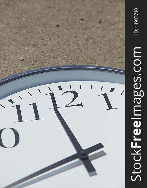 Big white clock on the road on a sunny day. Outdoors pictures with natural light taken with a Canon EOS 5D Mark II and the Canon 24-105mm. Big white clock on the road on a sunny day. Outdoors pictures with natural light taken with a Canon EOS 5D Mark II and the Canon 24-105mm.