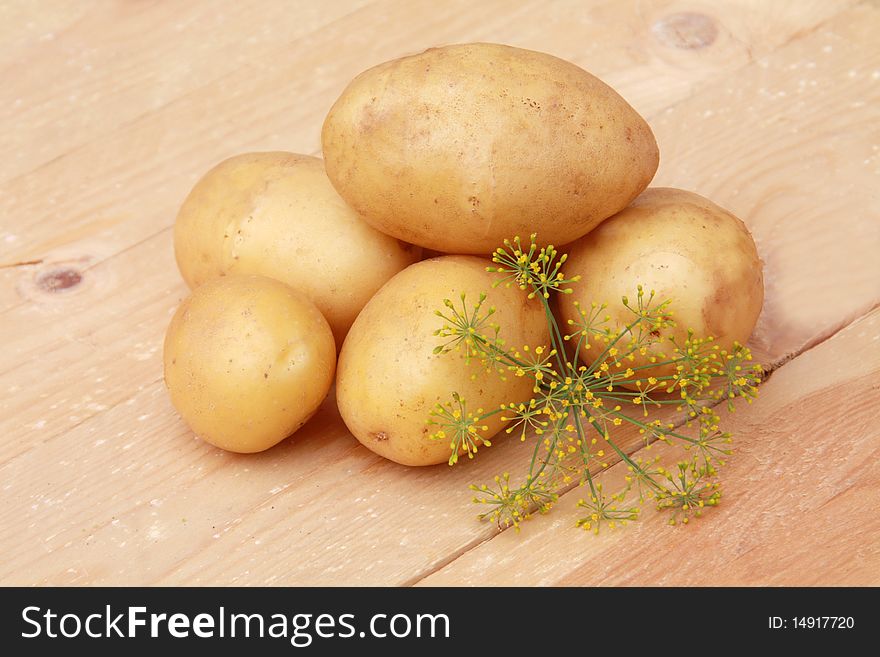 Raw potatoes  on wooden background