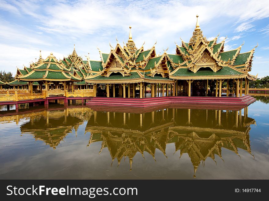 A green pavilion decorated by gold oriental texture on the lake. A green pavilion decorated by gold oriental texture on the lake