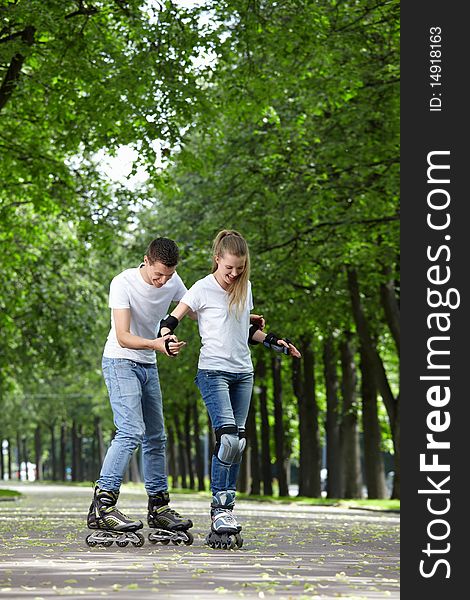 The guy and the girl go for a drive on rollers. The guy and the girl go for a drive on rollers