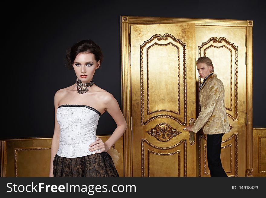 The beautiful girl and the young man in a gold interior. The beautiful girl and the young man in a gold interior
