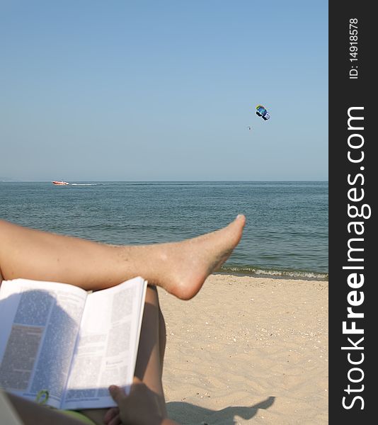 Two women feet on the calm and sunny, empty beach. Two women feet on the calm and sunny, empty beach.