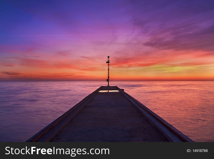 Pier at sunset in cinquale, italy