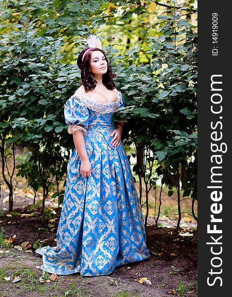 A portrait of lady in a blue baroque dress. A portrait of lady in a blue baroque dress