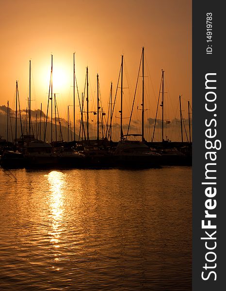 Hot sunset over marina with boats. Hot sunset over marina with boats