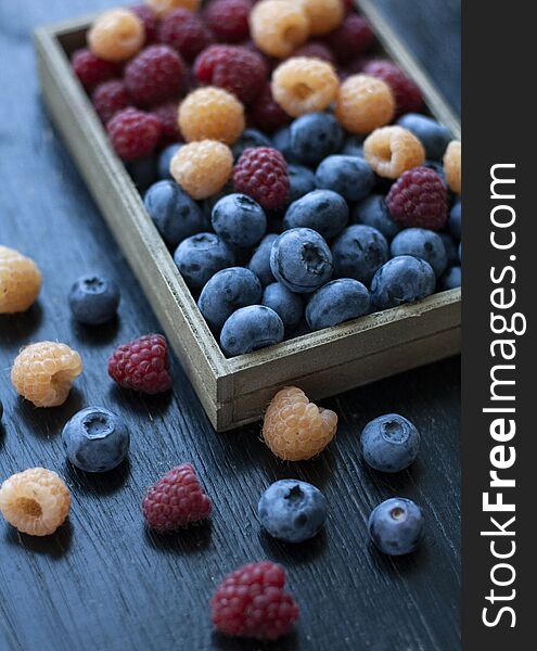 A tasty and healthy snack: a box of raspberries and blueberries