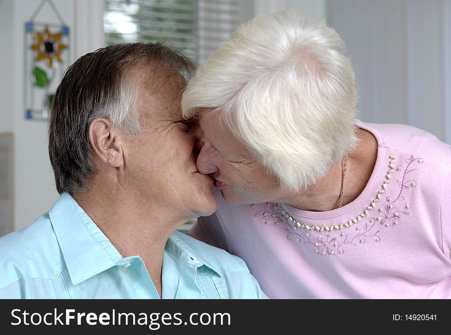 Senior romantic couple shares some intimate moments at their home. Senior romantic couple shares some intimate moments at their home.
