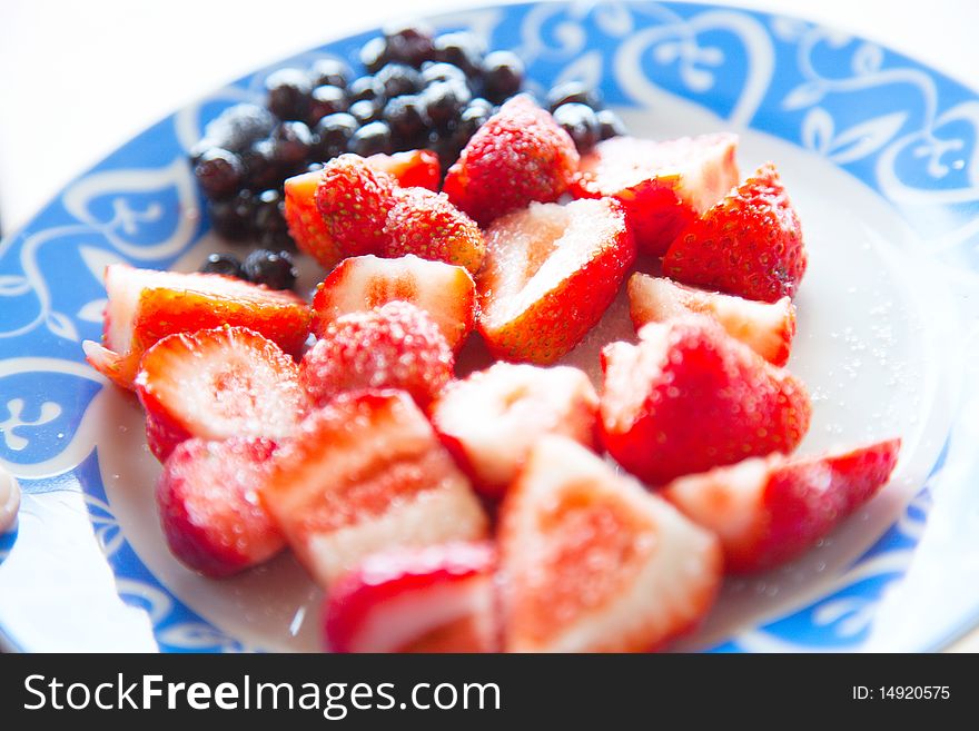 Fresh strawberries with sugar on the plate
