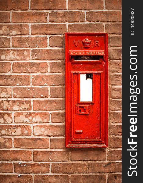 Victorian mail box abstract against a brick wall with blank white space for copy. Victorian mail box abstract against a brick wall with blank white space for copy