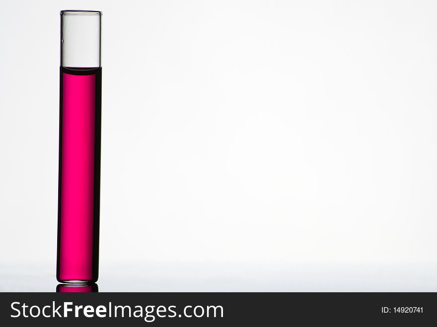 Test tube filled with colored liquid on white