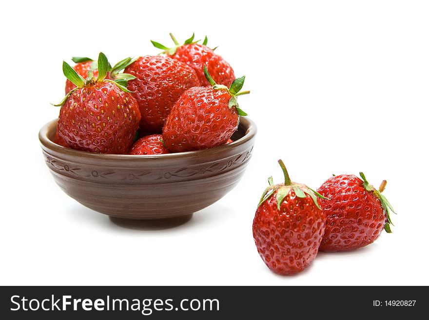 Fresh strawberries in the bowl isolated on white. Fresh strawberries in the bowl isolated on white