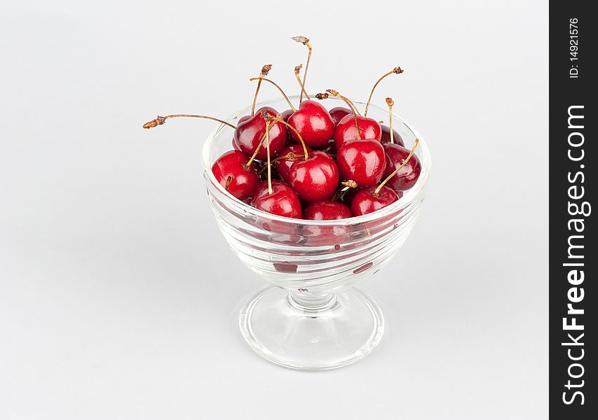 Fresh red cherry isolated on gray