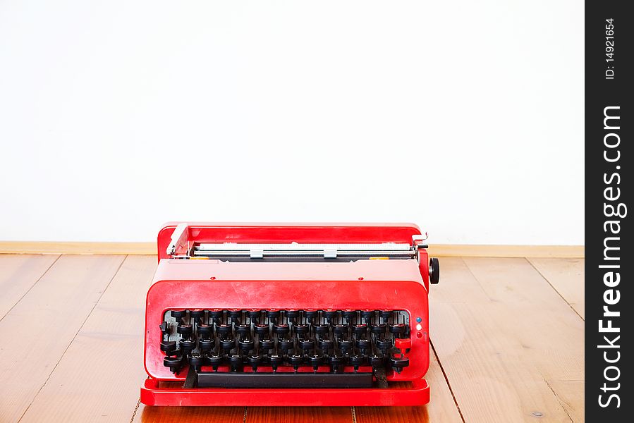 Old red typewriter on a parquet. Old red typewriter on a parquet