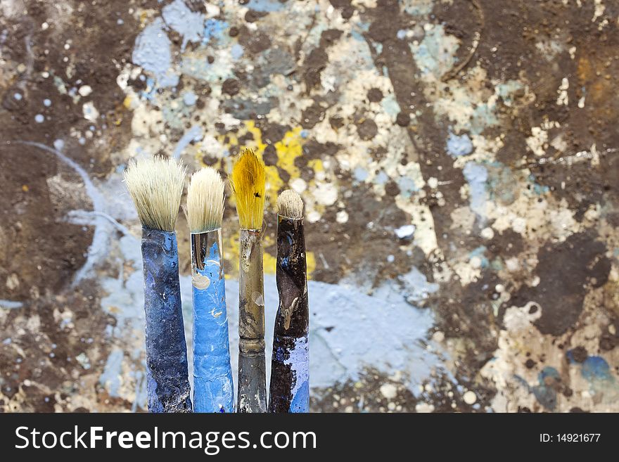A set of Paintbrushes on a painted background