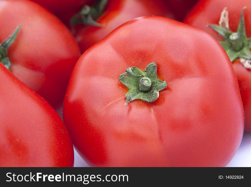 Isolated tomatoes, close up on white background