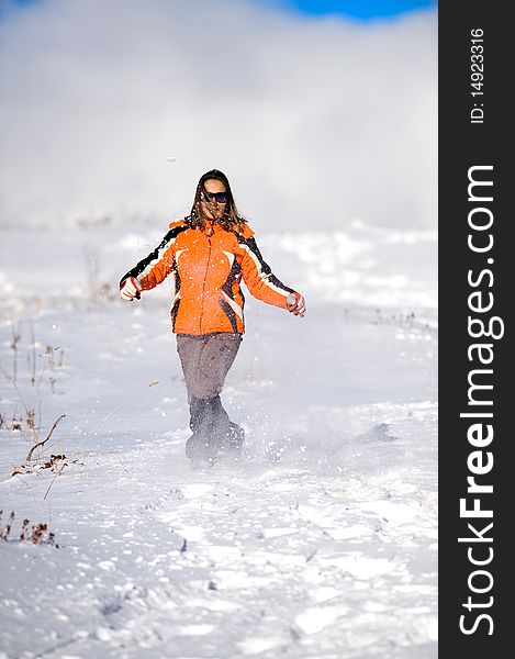 Young beautiful woman running on the snow