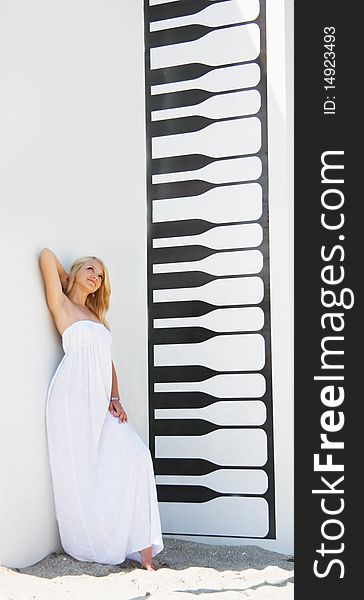 Young beautiful girl posing next to drawn piano keyboard