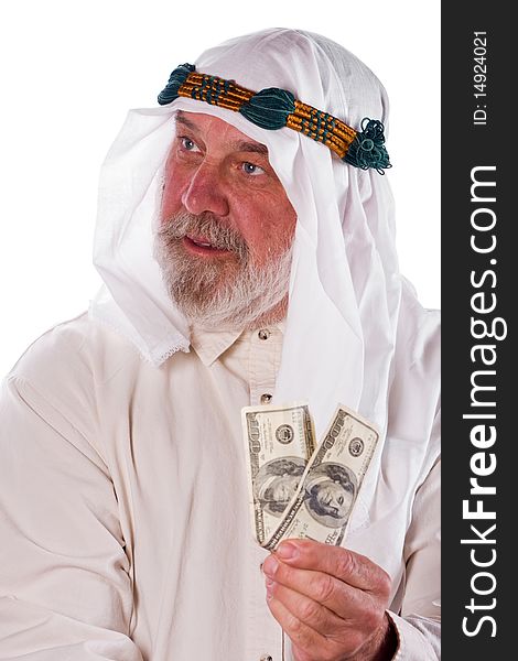 Older man in traditional Arab clothes holds up hundred dollar bills. Older man in traditional Arab clothes holds up hundred dollar bills.
