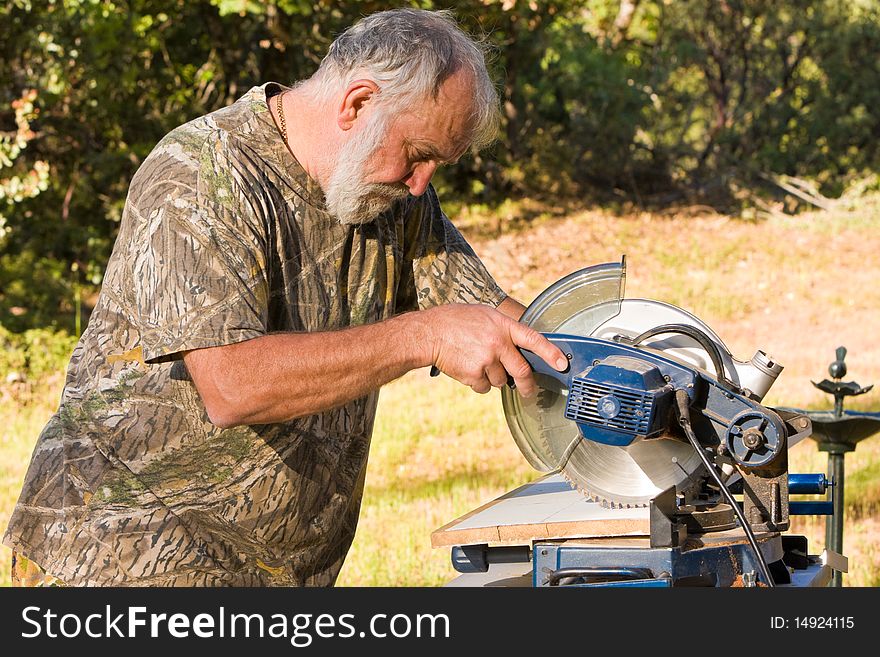 Senior Man Cutting Wood