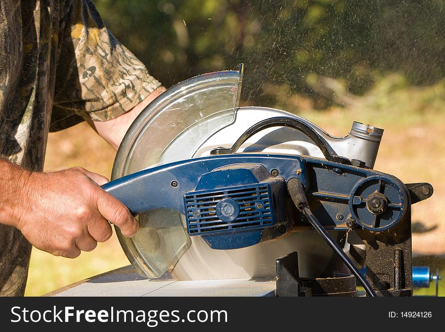 Man cutting wood with an electric saw. Man cutting wood with an electric saw.