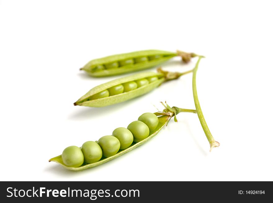 Green peas pods on a white background