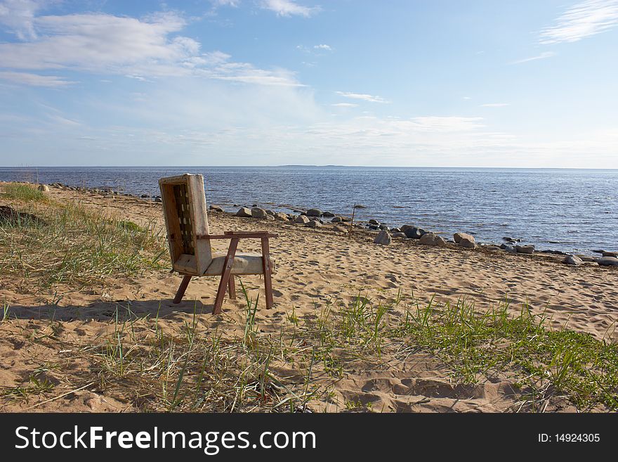 The old chair on a wild beach.