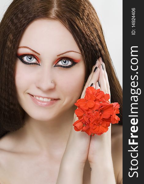 Close-up beautiful woman with bright make-up holding flower. Close-up beautiful woman with bright make-up holding flower