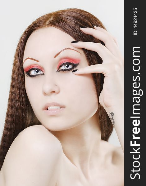 Close-up portrait of a young, beautiful caucasian woman with black nail polish and dark make-up