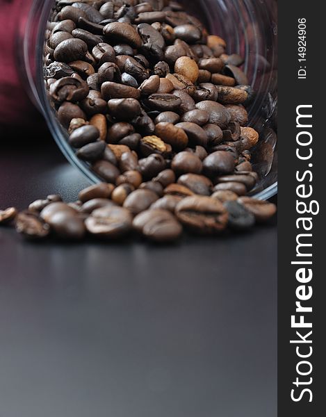 Pure glass with coffee granules on black table. Pure glass with coffee granules on black table