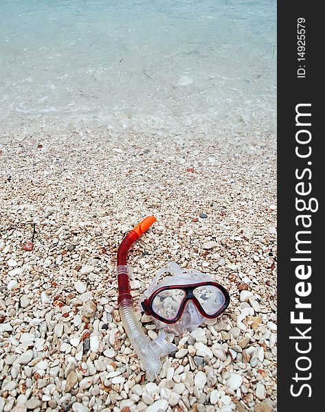 A diving mask and snorkel by the sea