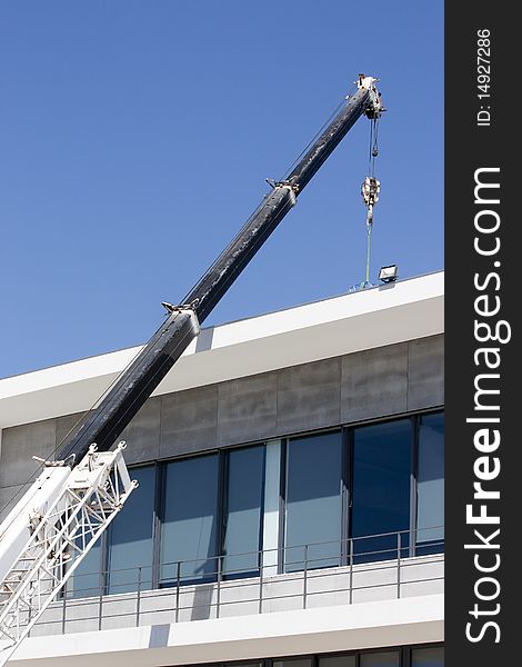 Mobile construction crane delivering materials