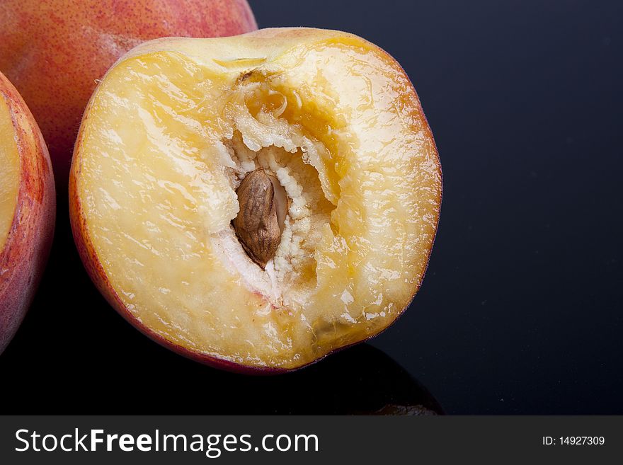 Detail of a sliced peach over a black. Detail of a sliced peach over a black