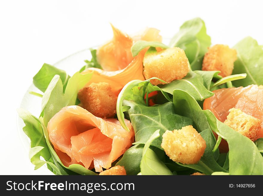 Bowl of salad greens with smoked salmon and croutons. Bowl of salad greens with smoked salmon and croutons