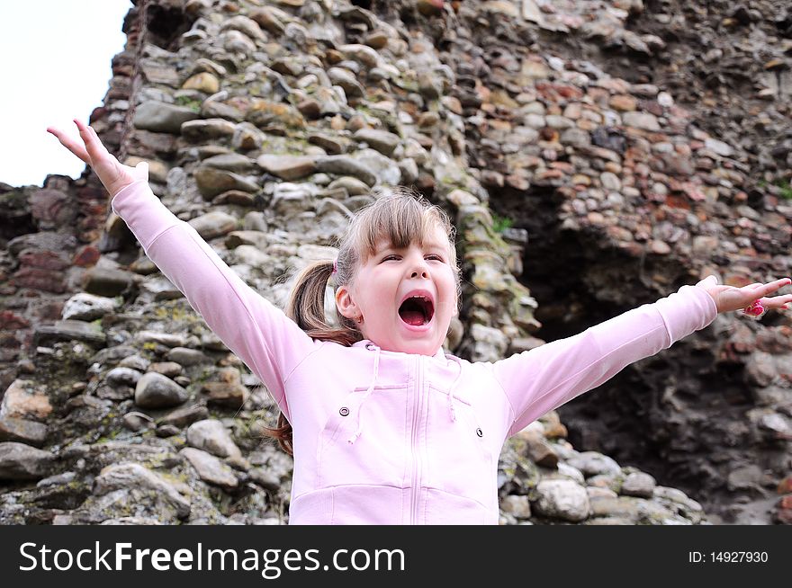 Girl with open arms screaming in happiness