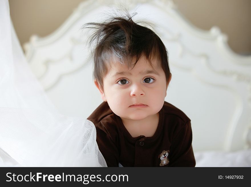 Little baby in bed after waking up from his nap.