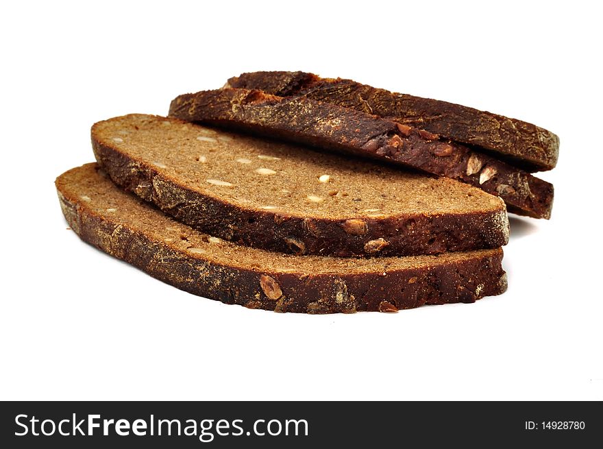 Sliced brown bread with sunflower seeds isolated on a white background