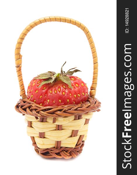 A fresh strawberry in a tiny basket isolated on a white background. A fresh strawberry in a tiny basket isolated on a white background