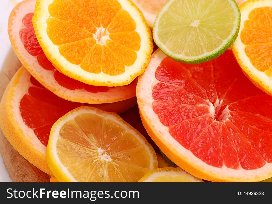 Slices of five various citruses background