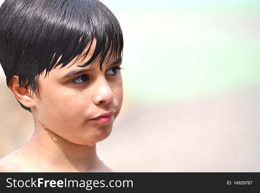 An adorable little boy is looking to the side with a confused expression in his face. An adorable little boy is looking to the side with a confused expression in his face.