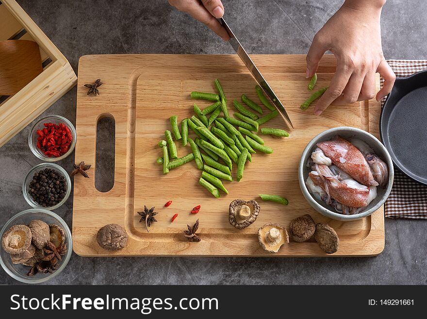 Top View of Hands Sliced lentils On a cutting board In making healthy food menus From many squid and spices. Top View of Hands Sliced lentils On a cutting board In making healthy food menus From many squid and spices