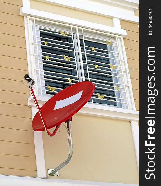 Satellite dish on the outside of the wall at home