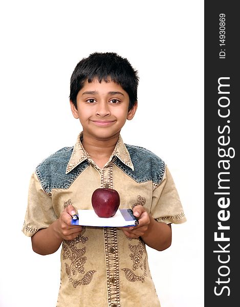 An handsome Indian kid holding apple and a book