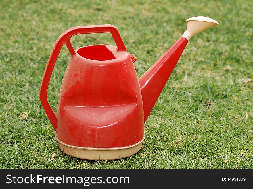 An old dusty watering can. An old dusty watering can